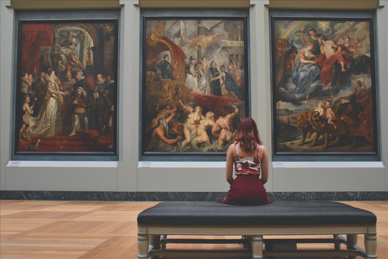 A girl looking at paintings in a museum
